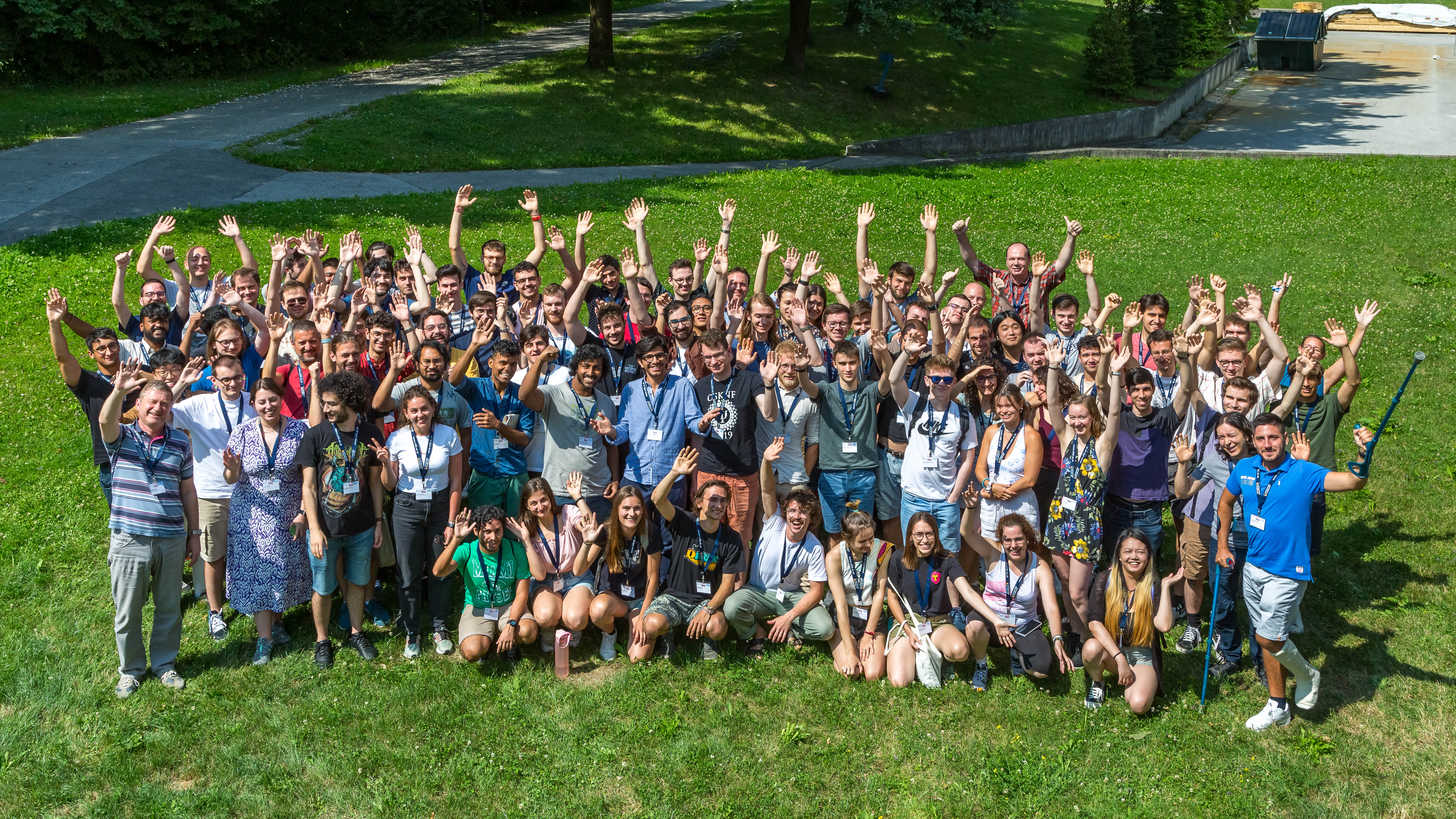 group photo of participants of IC23, waving